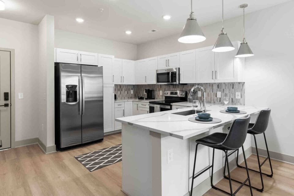 Modern Kitchen with Island Seating-Fully equipped kitchen makes cooking a breeze. Enjoy the convenience of a spacious island with bar seating, perfect for a quick breakfast or a cocktail.