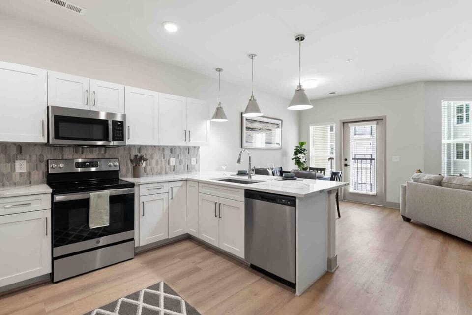 A Kitchen Designed for Convenience-Enjoy a fully equipped modern kitchen with sleek stainless steel appliances. The open layout and adjacent dining area make it perfect for meals.