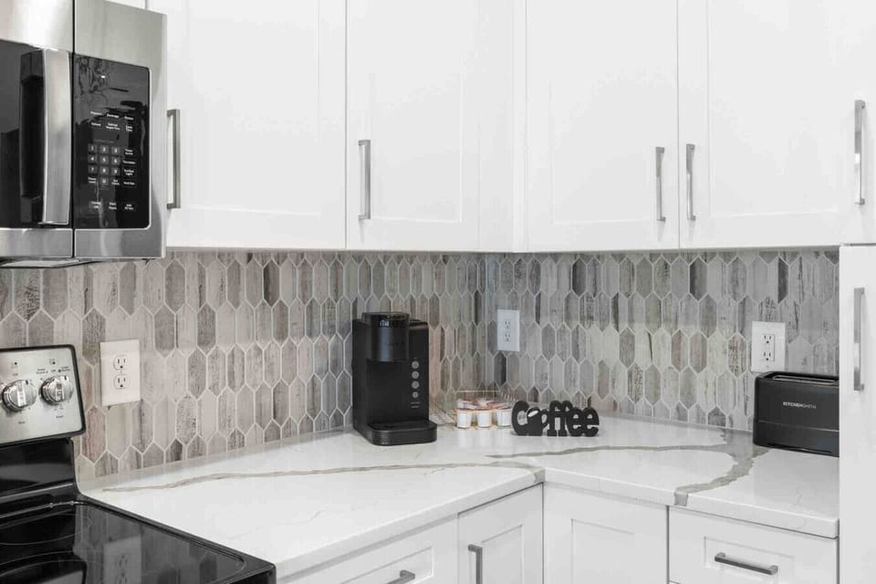 Coffee Corner-Modern kitchen nook with sleek backsplash, coffee maker, and essentials for a perfect morning brew. Bright and functional space to start your day with comfort and style.