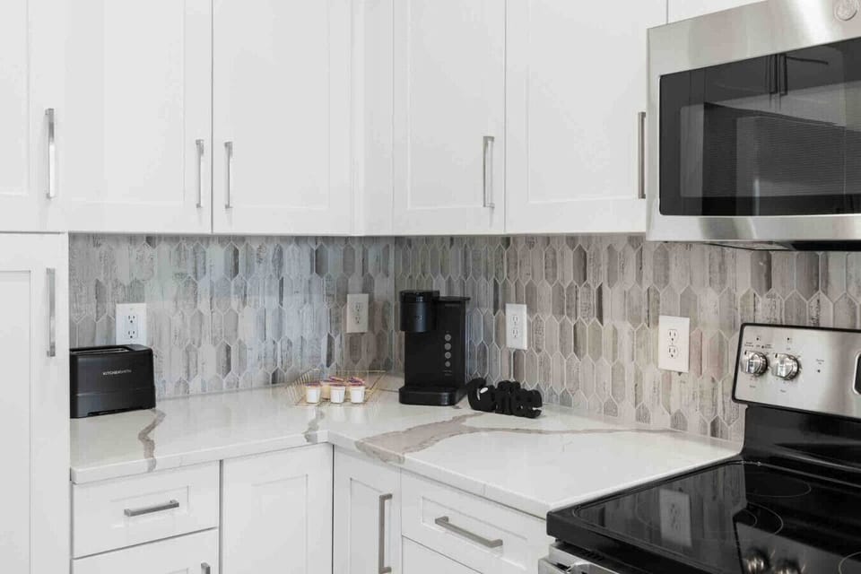 Start Your Day Right-Get your morning coffee fix with the provided coffee maker and toaster, perfect for a quick breakfast before exploring. The modern kitchen features sleek countertops and appliances to make your stay feel like home.