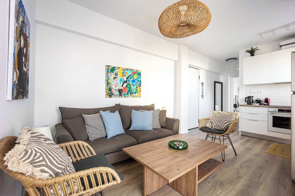 Comfortable and beautiful living space with modern kitchen nearby, offering style, functionality, and welcoming warmth.