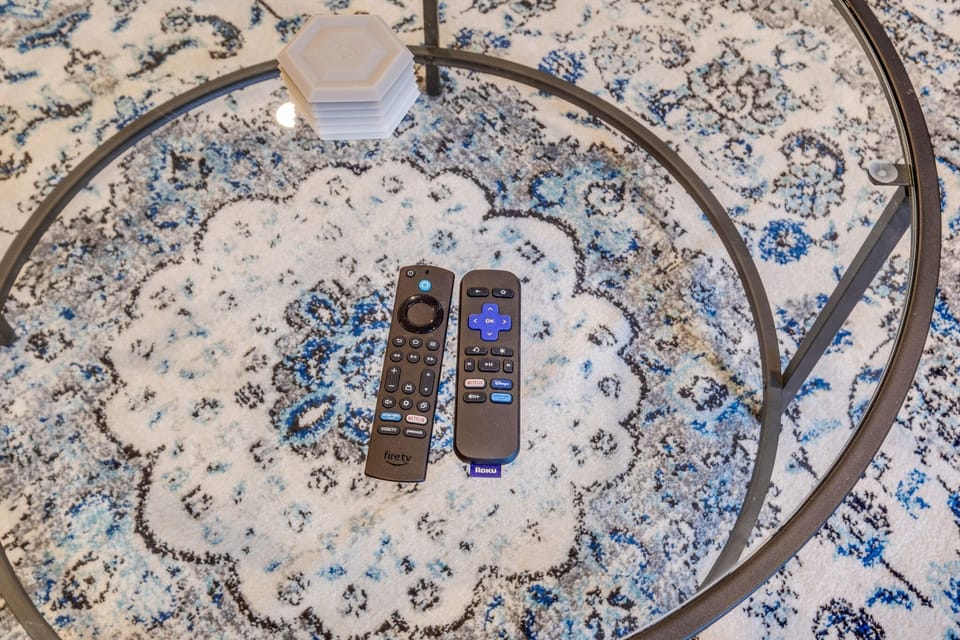 Enjoy seamless entertainment with the remote control for the television, conveniently placed for easy access.