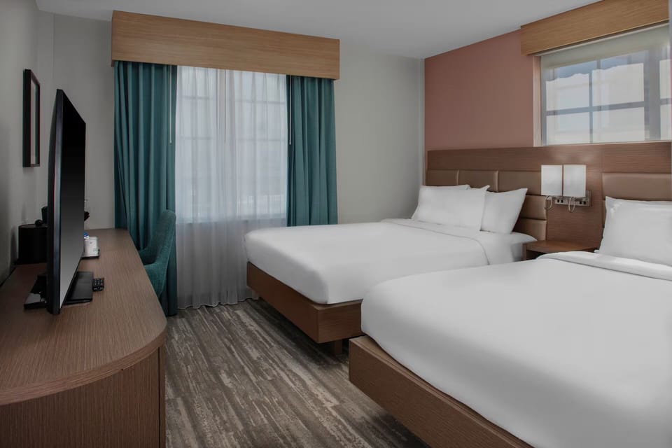 Settle in comfortably with workspace convenience and cozy twin beds.