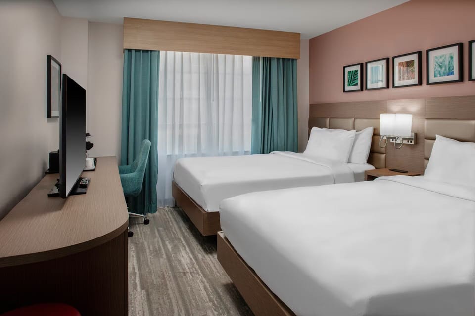 Unwind in crisp linens with calming city-and-sky views.