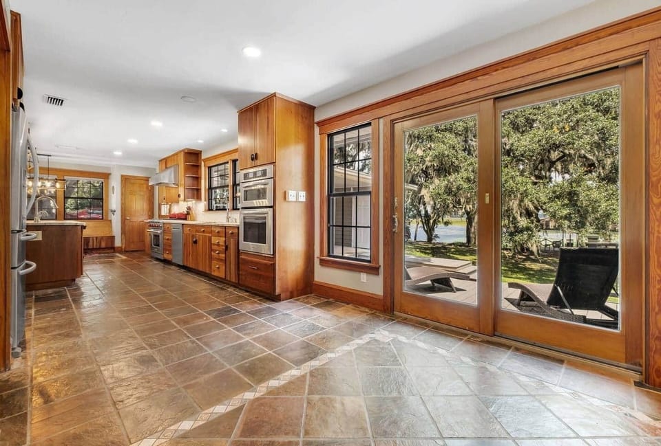Oversized french doors lead to outdoor patio.