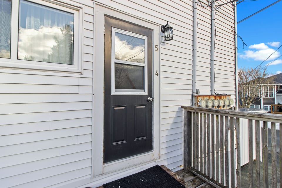 Secure entry to your private suite with a dedicated wooden deck area. Easy access for a seamless check-in experience.