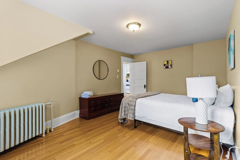 Stylish Bedroom & Dressing Area. Thoughtfully decorated with a full dresser and mirror, offering plenty of space to unpack and feel right at home.