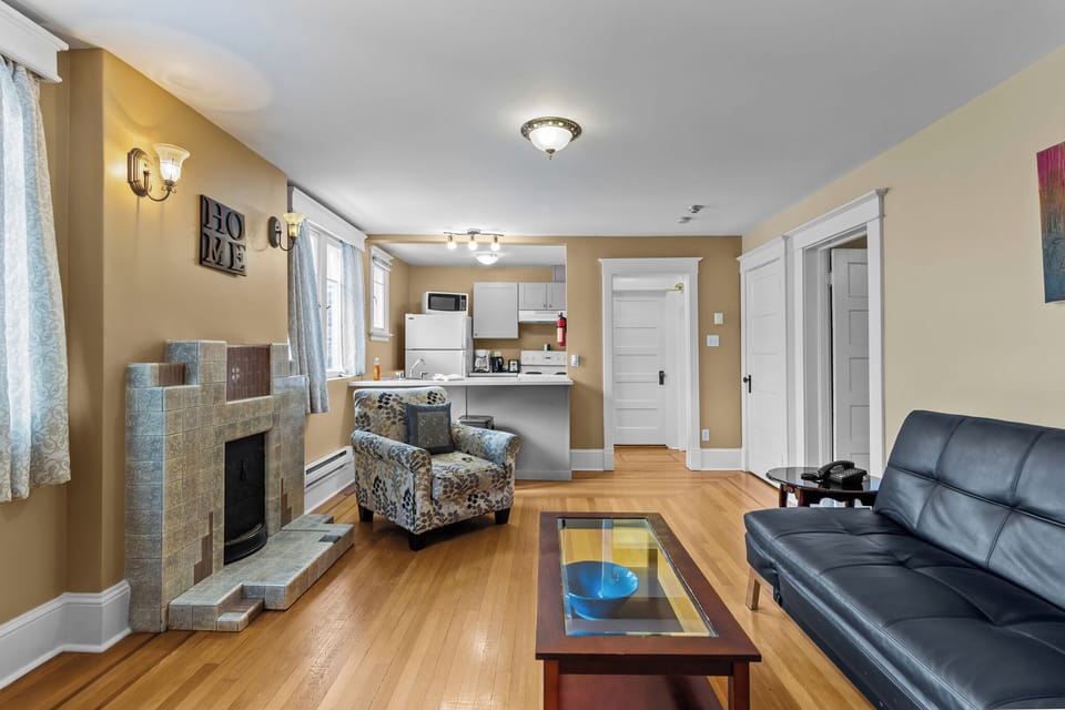 Open-Concept Living & Dining. Enjoy the flow between the cozy living area and the breakfast bar, perfect for morning coffee and social evenings.
