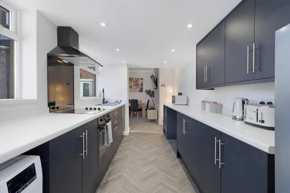 Kitchen equipped with all essentials, including a washer & dryer, oven, fridge and full cookware set.