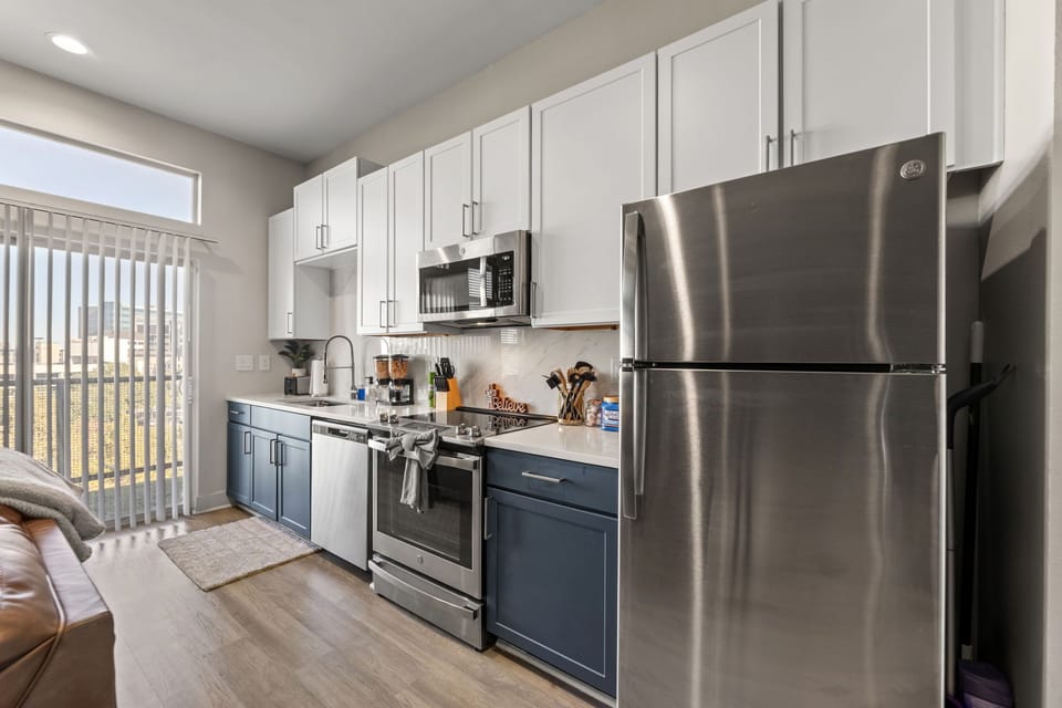 Modern kitchen with stainless steel appliances and all cooking essentials.