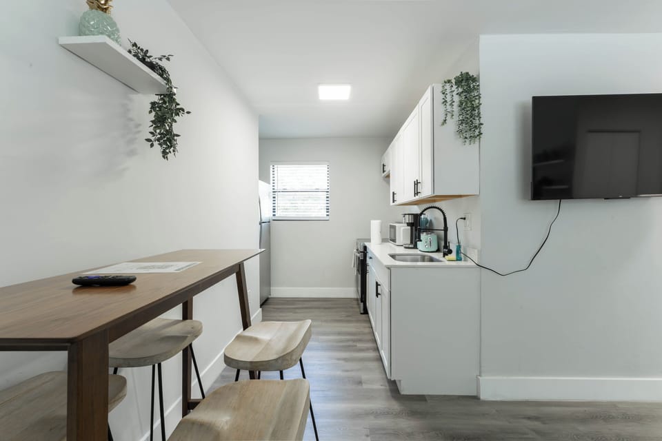 Cozy dining nook with a bar-style table—perfect for coffee or takeout.