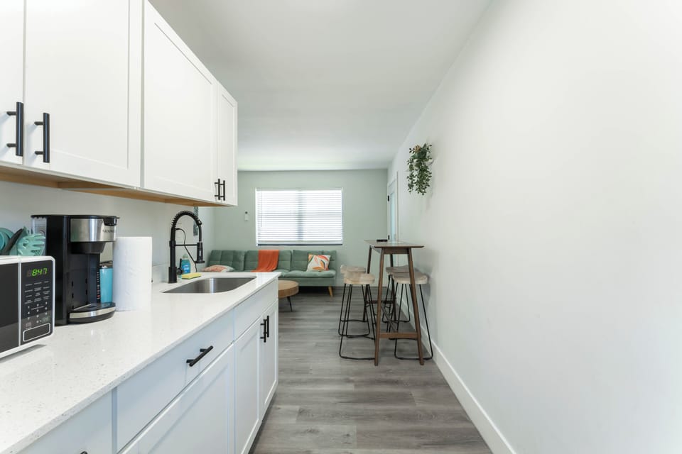 Fully stocked kitchen with bar seating, ideal for snacks or full meals.