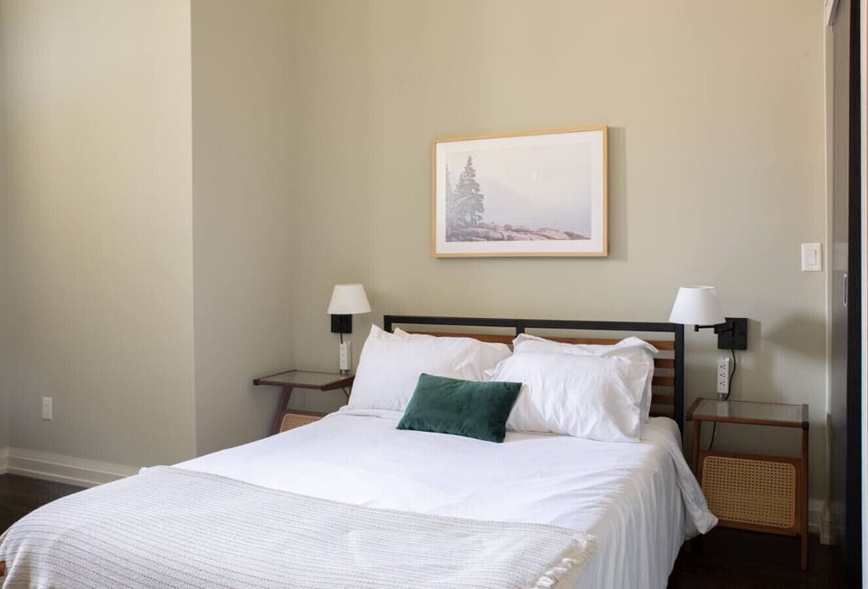 Bedroom #2 with queen size bed, dedicated workspace, and en-suite bathroom