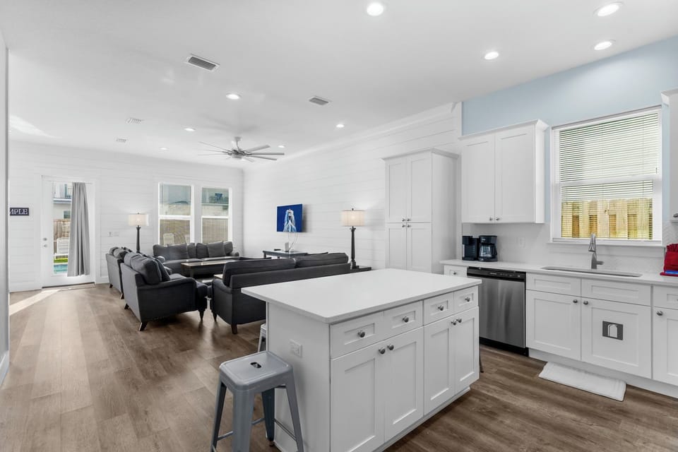 Spacious open-plan living area with modern kitchen and comfortable seating.