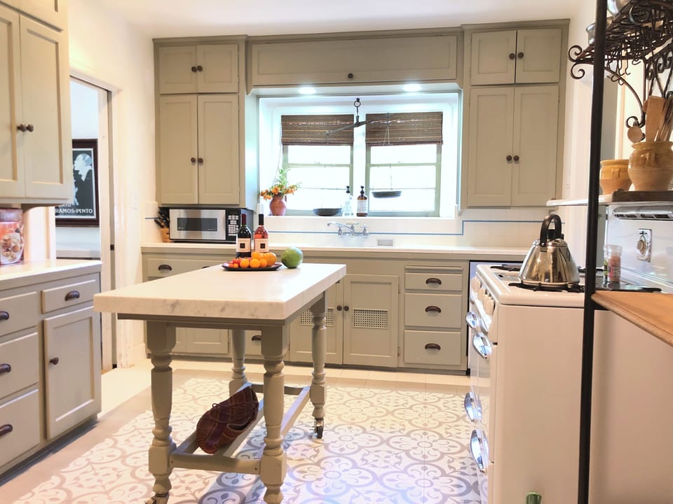 Renovated kitchen with island over pattern floor.