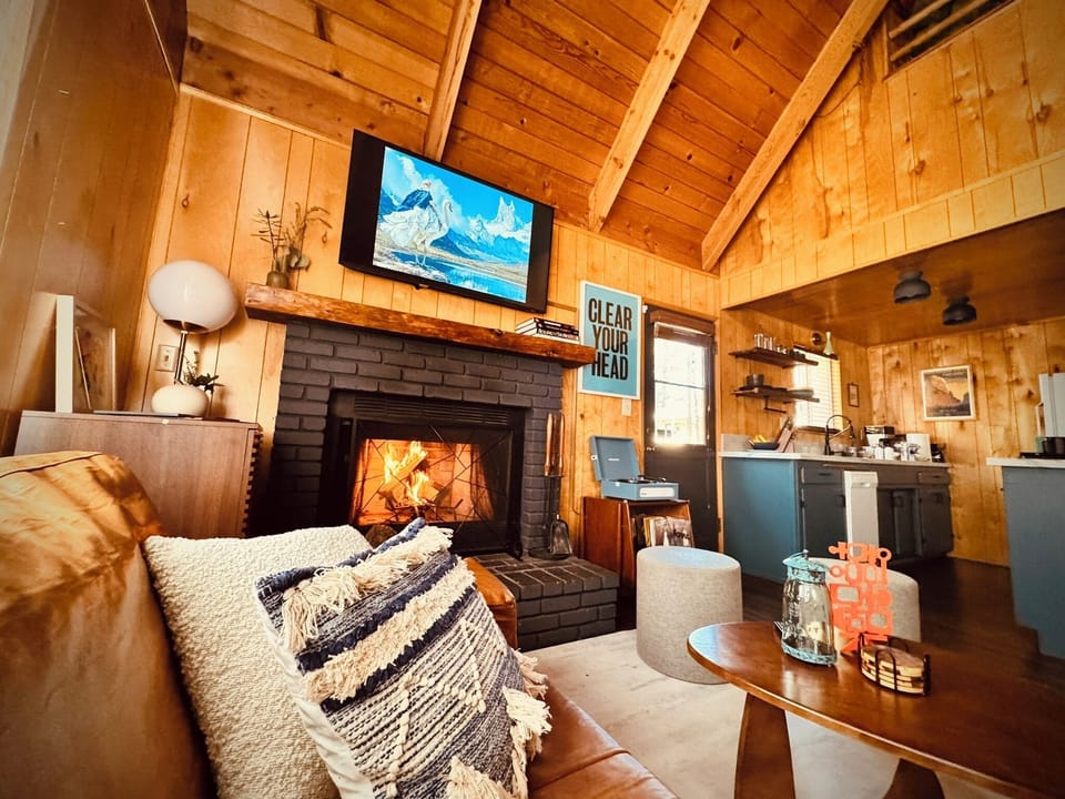 Comfortable leather sofa beside the fire with views of the loft.