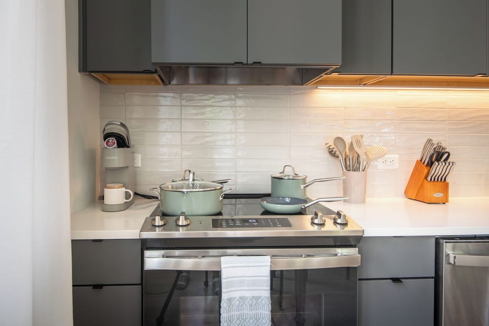 Fully equipped kitchen with stove, cookware, and essentials