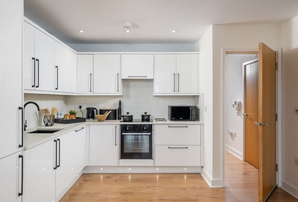 12 Ocean One, Newquay: Kitchen with an electric oven, induction hob, microwave, fridge/freezer, coffee machine and dishwasher