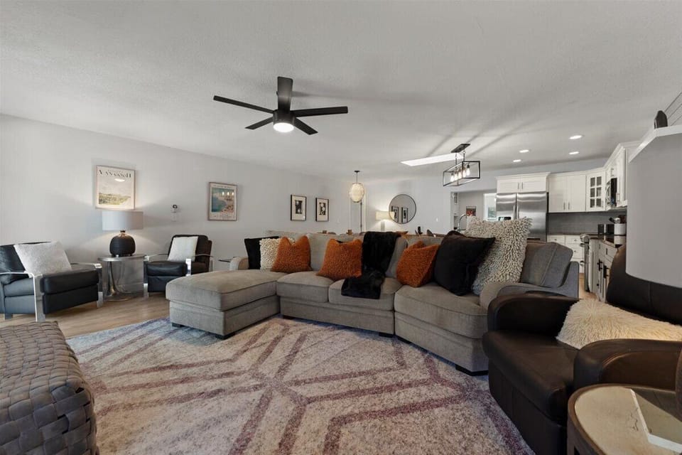 Spacious open concept living room with oversized sectional smart TV and modern decor ideal for family gatherings