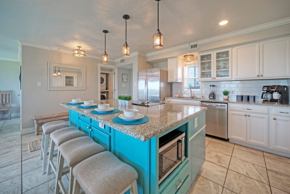 Sleek, modern kitchen with center island table and barstool seating.