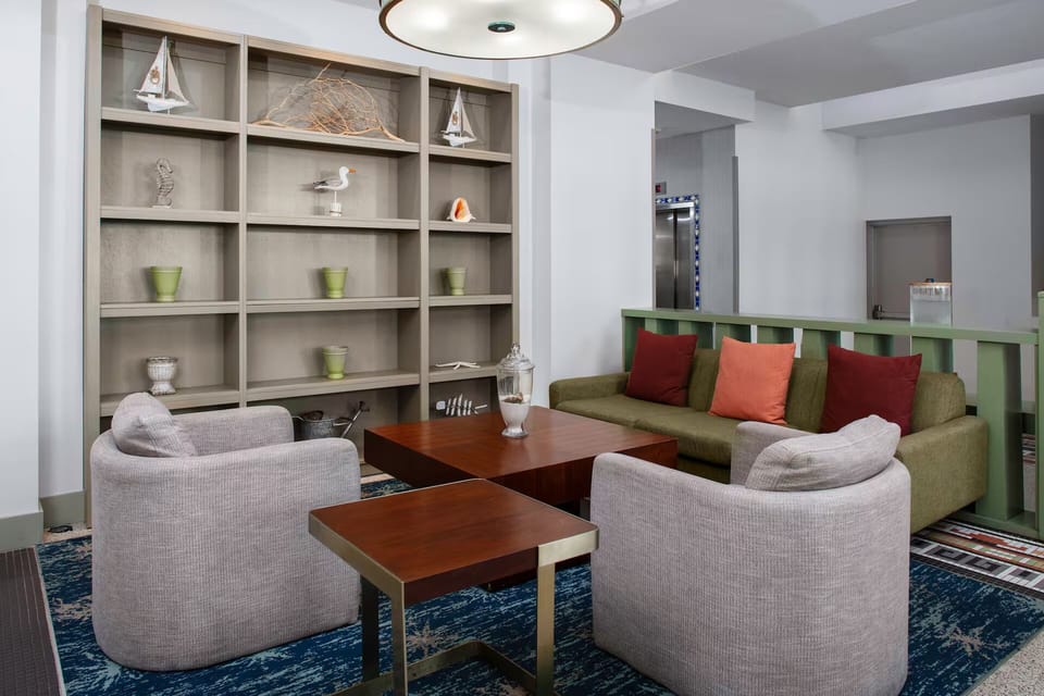 Gather and unwind in a modern lounge with a warm, ambient glow.