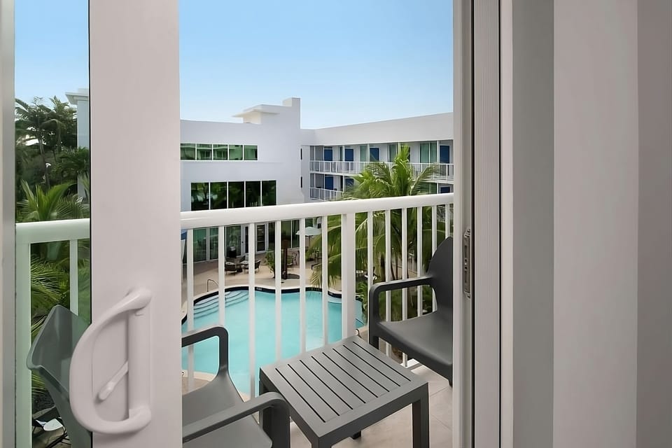 Sip a drink on the balcony overlooking the sparkling pool below.