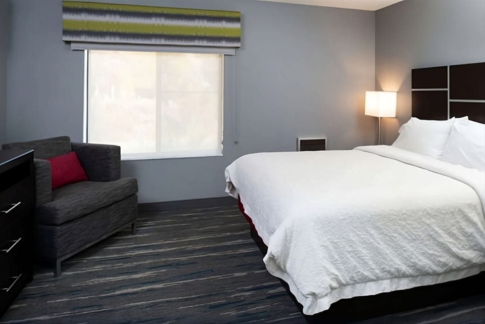 Drift off in crisp linens beside soft, warm bedside lighting.