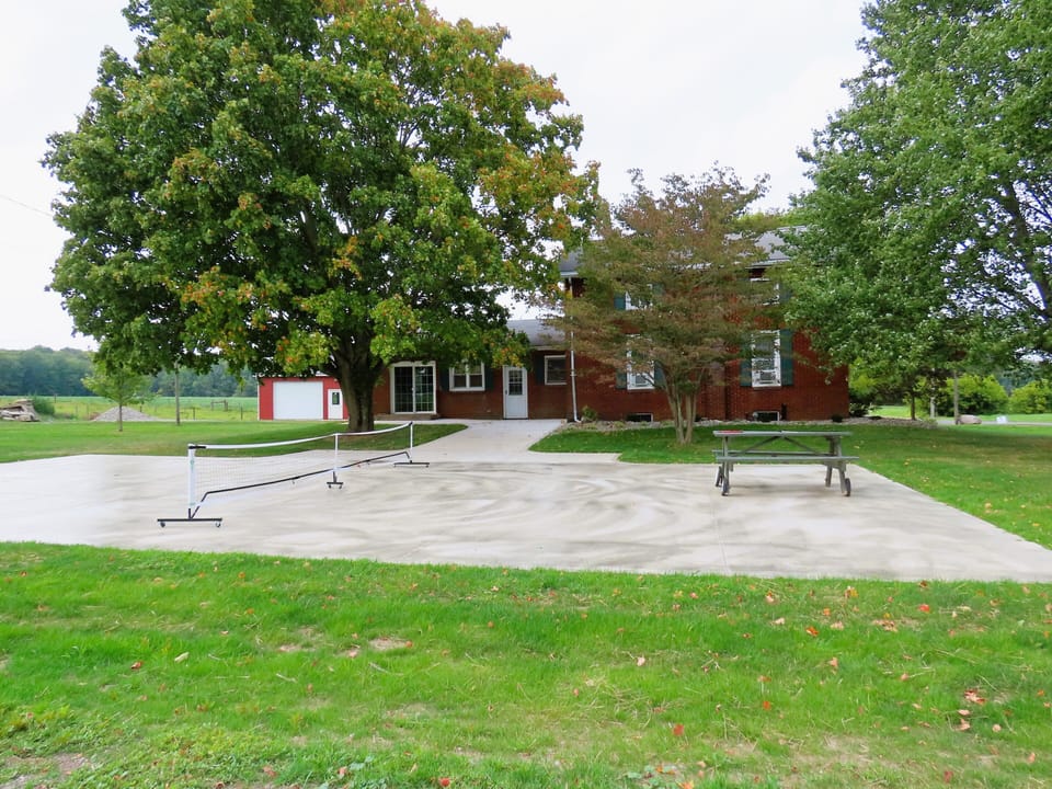 Backyard with patio and pickle ball court.