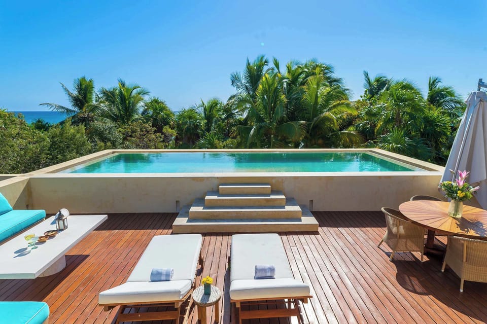 Rooftop Pool | Swim above the jungle with sea on the horizon