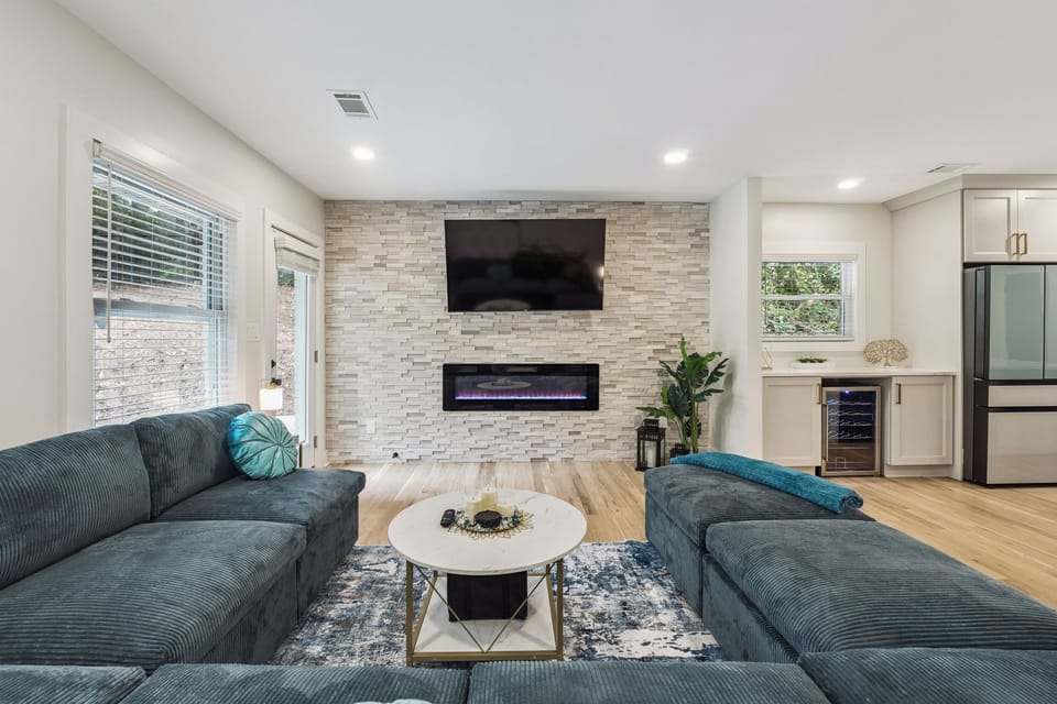 Living Room: sofa, Smart TV, electric fireplace, access to back patio