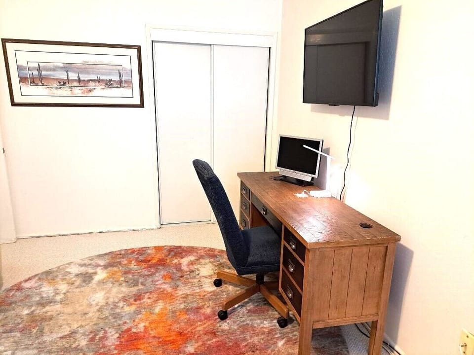 The separate work station with monitor in the 2nd bedroom.