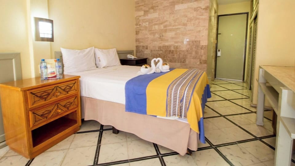 Unwind on crisp linens in a bright, welcoming room.