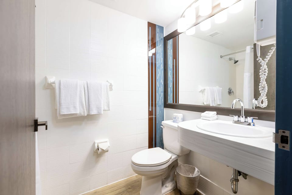 Ease into the evening with a spotless vanity and bright mirror.