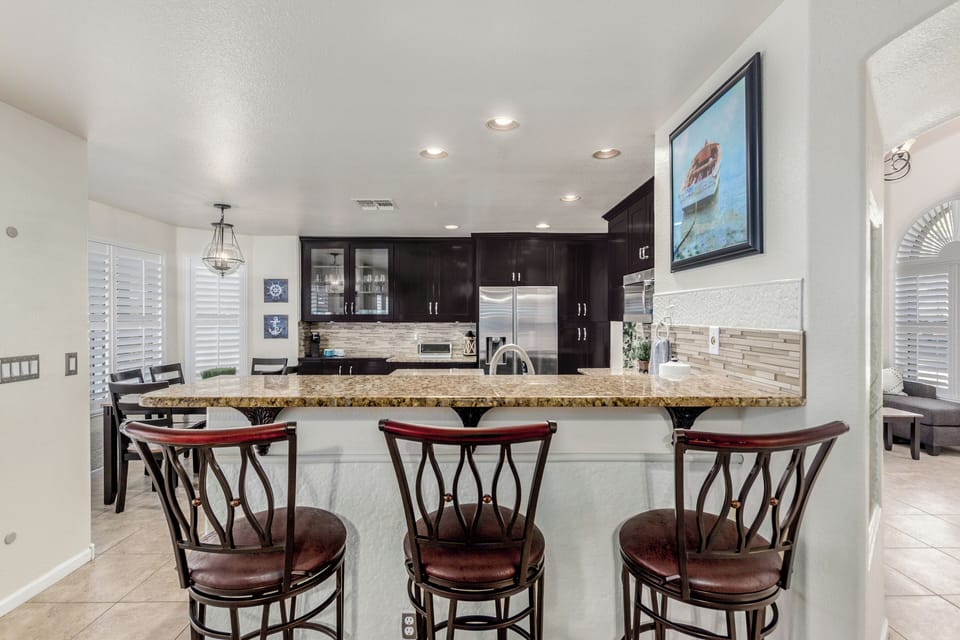 Spacious Kitchen with cooking essentials, barstool seating 