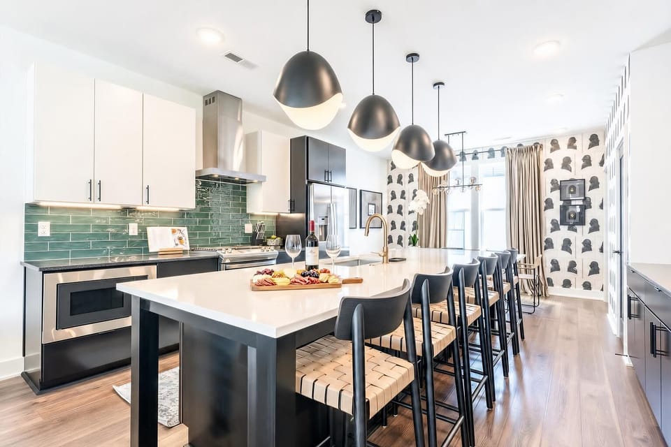The kitchen island keeps the cook in the middle of conversation, with bar seating and pendant lighting that turn meal prep into part of the gathering