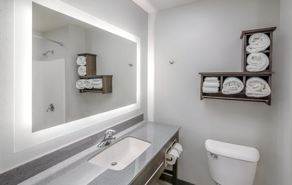 Enjoy extra towel storage and a clean, calming bathroom setup.