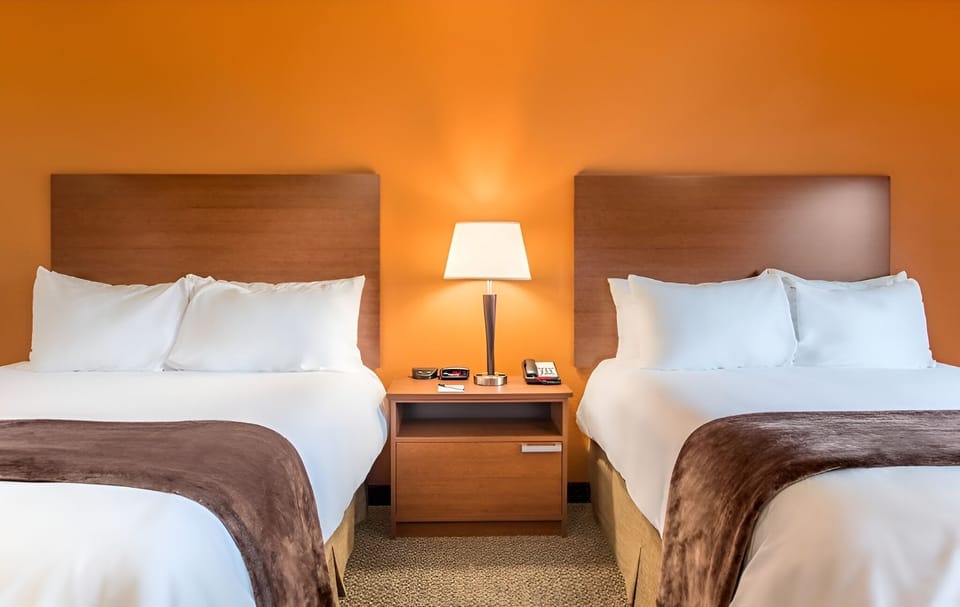 Drift off fast in two plush beds with warm bedside glow.