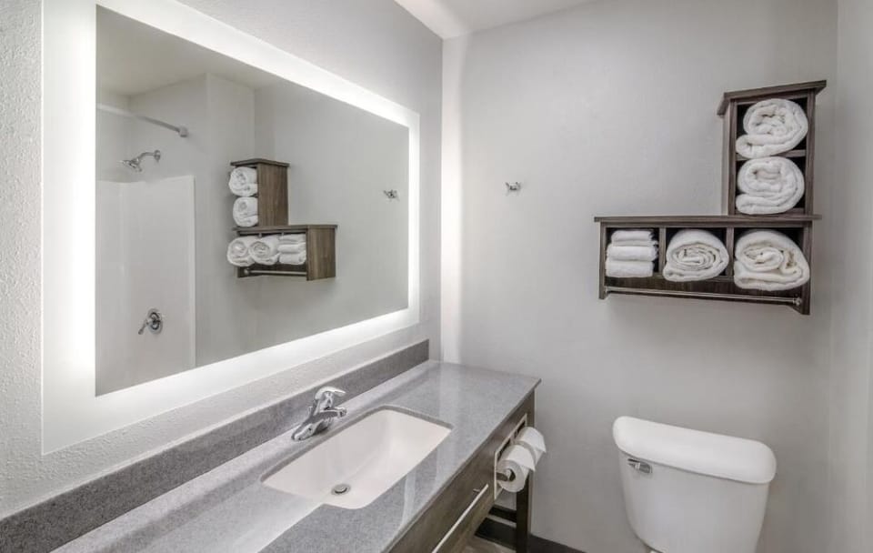 Refresh comfortably with bright vanity lighting and plush towels.