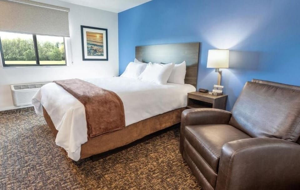 Relax in a serene king bed with calming blue accents.