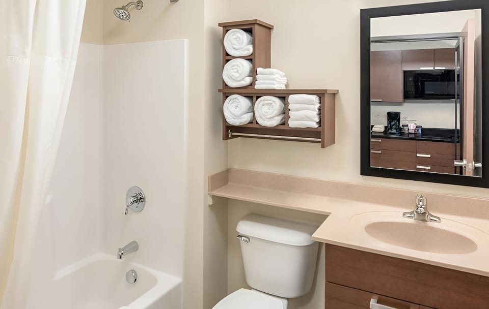 Refresh with a spotless bath setup and fluffy towels ready.
