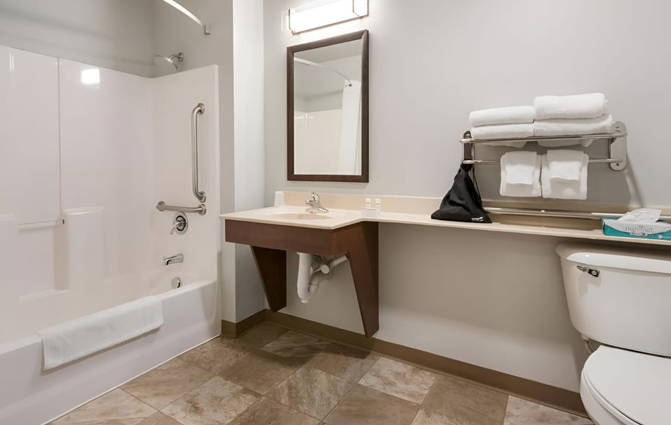 Enjoy added comfort with a spacious tub and grab bars.