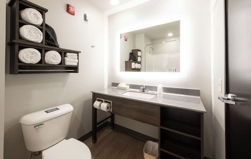 Refresh and reset with bright vanity lighting and clean linens.