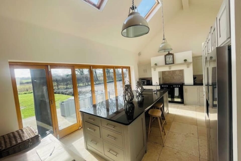 South facing bifold doors and Mark wilkinson hand made painted kitchen 