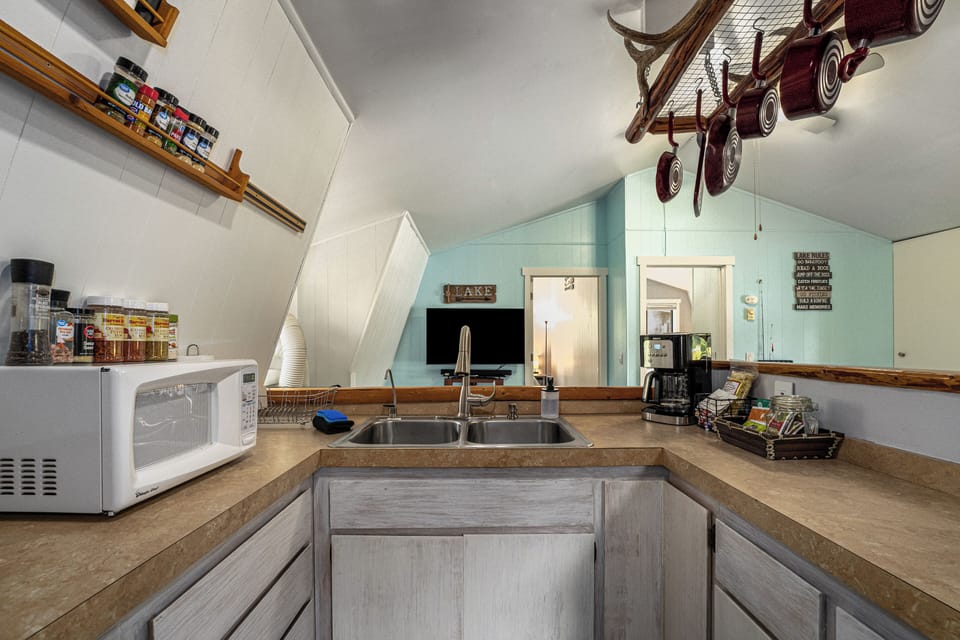 Easily choose the pan you need with this handy pan rack above the counter | Upper Level