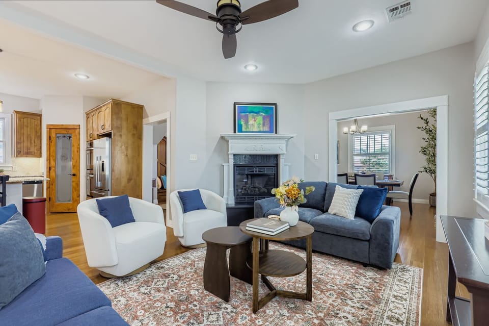 Bright and airy lounge area with stylish décor and ceiling fan.