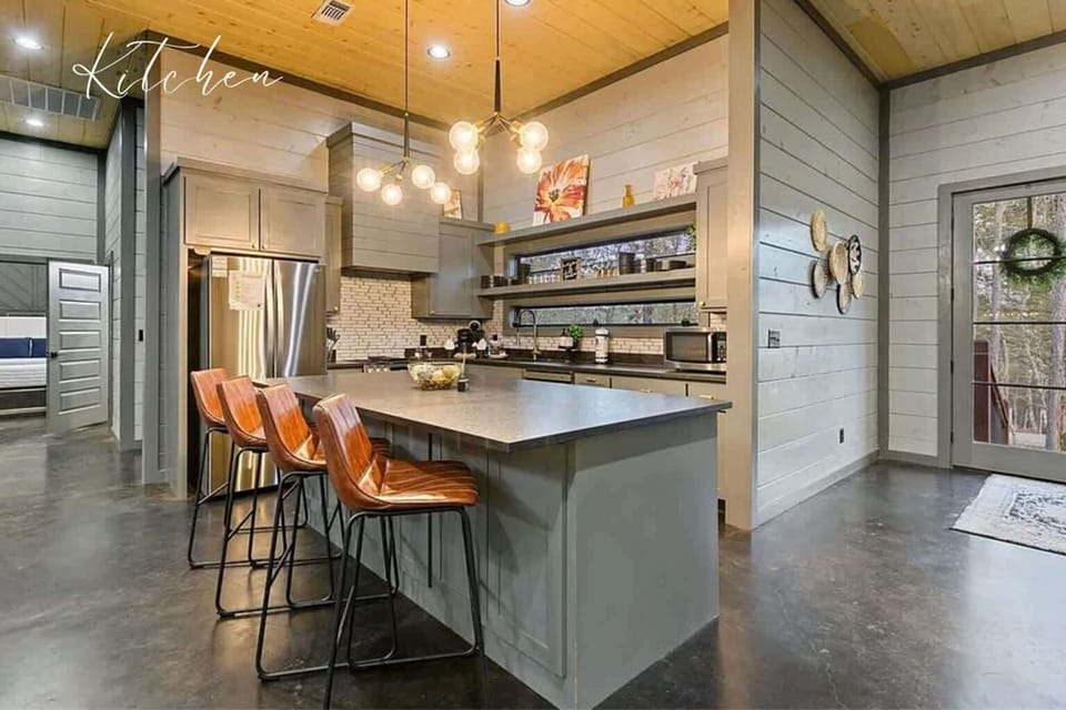 Chef’s kitchen with large island, modern appliances, and bar seating