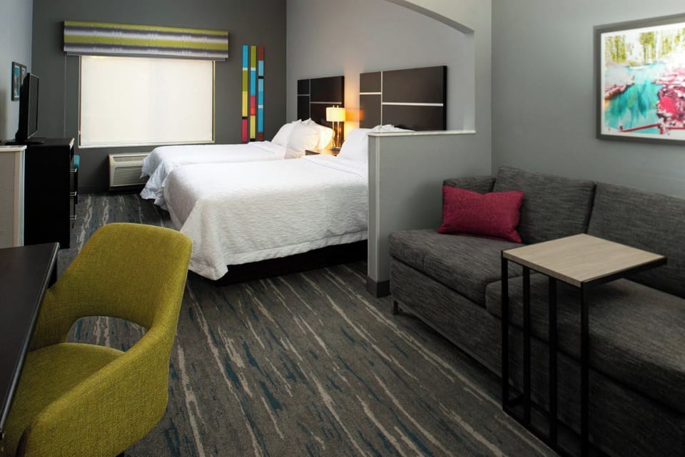 Unwind together in a roomy double setup with cozy seating.