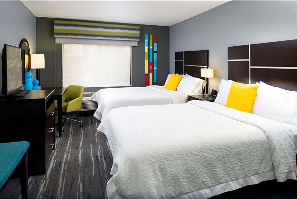 Unwind in bright double-queen comfort with bold modern style.