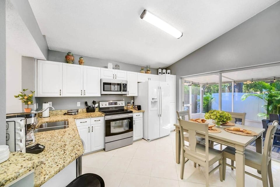 Fabulous eat-in kitchen with lovely granite counter tops, garbage disposal, dishwasher and loads of small electric appliances. If you want to toast bread,waffle, waffle or bake a  cake it can be done in this  naturally lit kitchen.