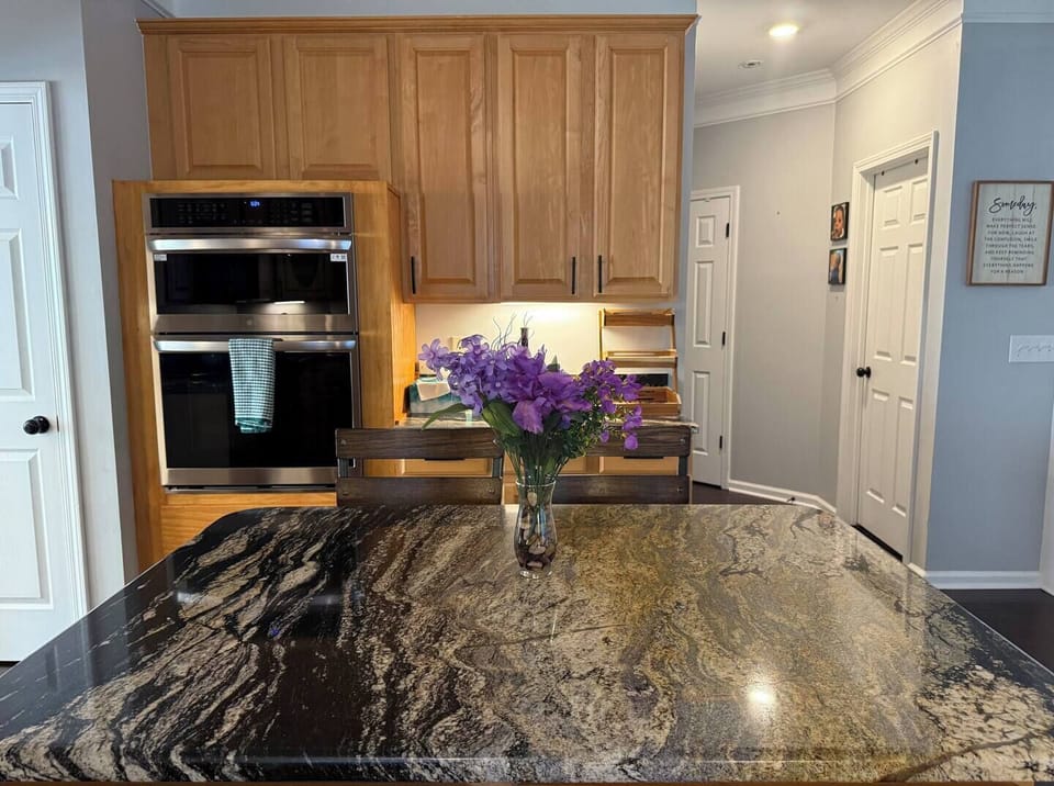 Spacious kitchen island paired with a sleek oven and microwave – perfect for cooking and gathering.
